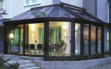 Зимовий сад, прибудований до зовнішнього кута будівлі з кутом складної форми